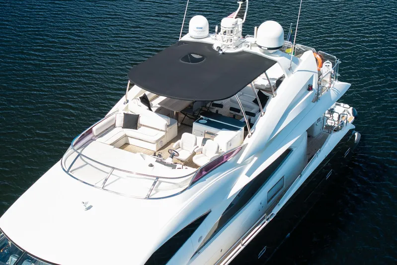 Sukha Yacht Photos Pics Luxurious 2008 Sunseeker 90 Yacht on calm water, featuring spacious deck and modern design.