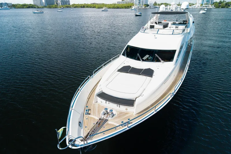 Sukha Yacht Photos Pics 2008 Sunseeker 90 Yacht cruising on calm waters, surrounded by other boats.