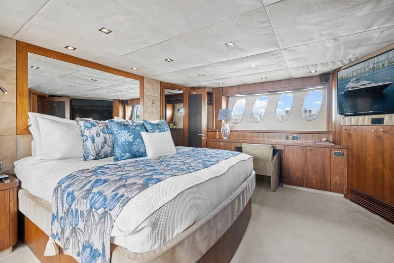 Sukha Yacht Photos Pics Luxurious bedroom interior of 2008 Sunseeker 90 Yacht with elegant wood finishes and ocean view.