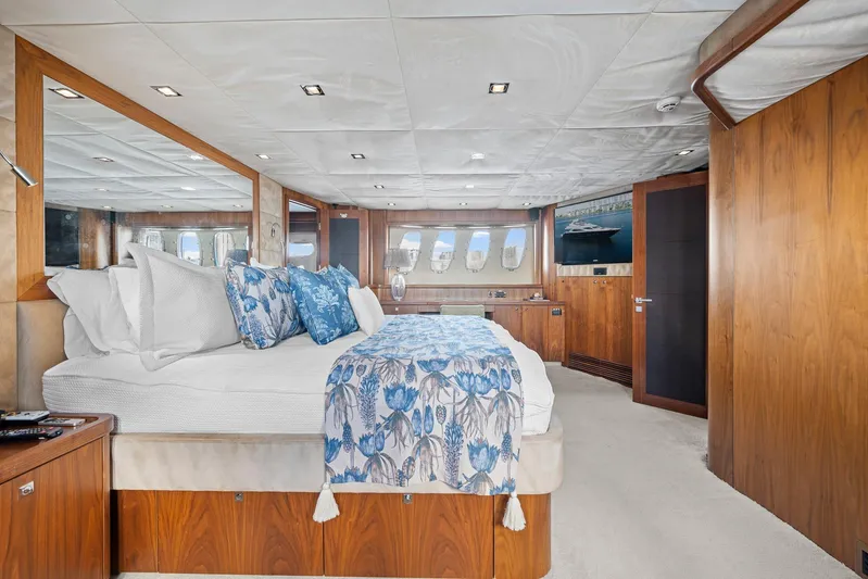 Sukha Yacht Photos Pics Luxurious 2008 Sunseeker 90 Yacht bedroom with elegant wood paneling and floral bedding.