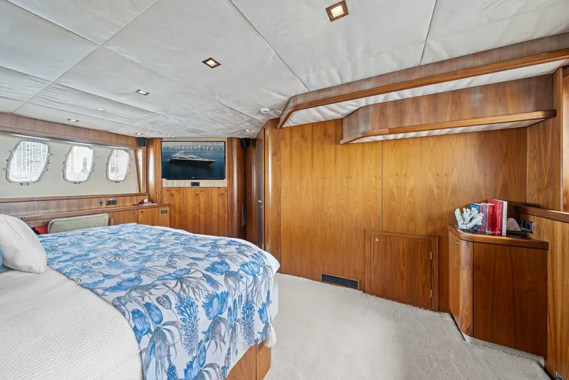 Sukha Yacht Photos Pics Luxurious 2008 Sunseeker 90 Yacht bedroom with wood paneling and floral bedding.