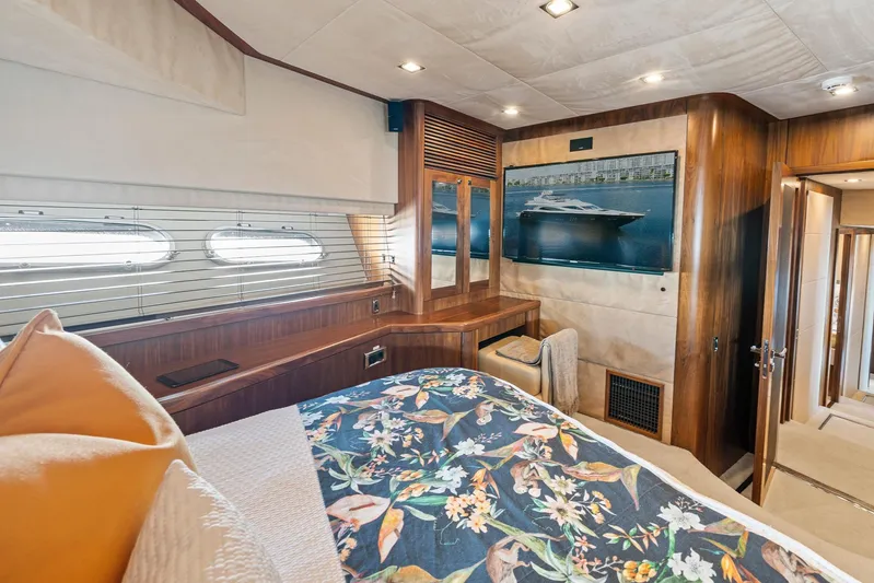 Sukha Yacht Photos Pics Luxurious 2008 Sunseeker 90 Yacht bedroom with floral bedding and elegant wood finishes.