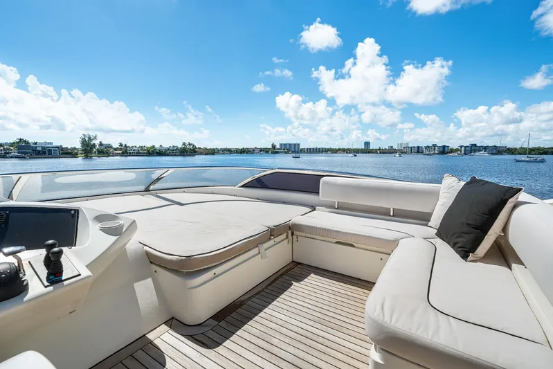 Sukha Yacht Photos Pics Luxurious 2008 Sunseeker 90 Yacht deck with plush seating, overlooking serene waters and skyline.