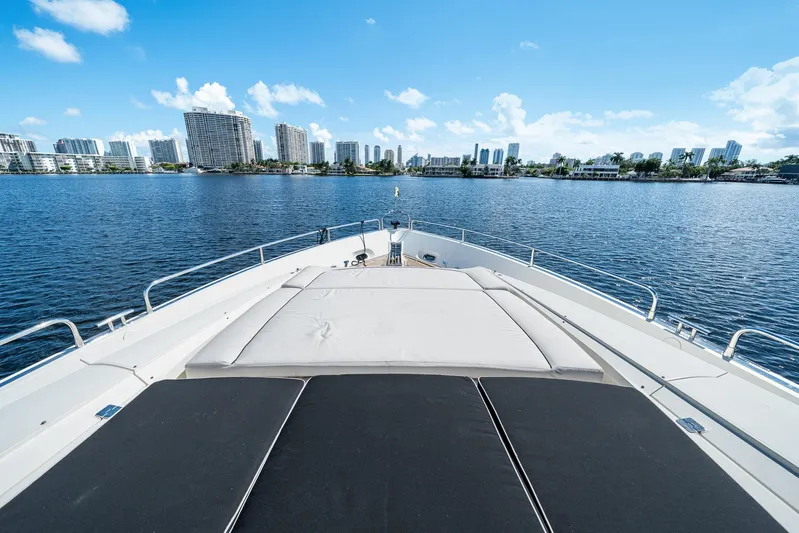 Sukha Yacht Photos Pics Sunseeker 90 Yacht 2008 cruising with city skyline in the background.
