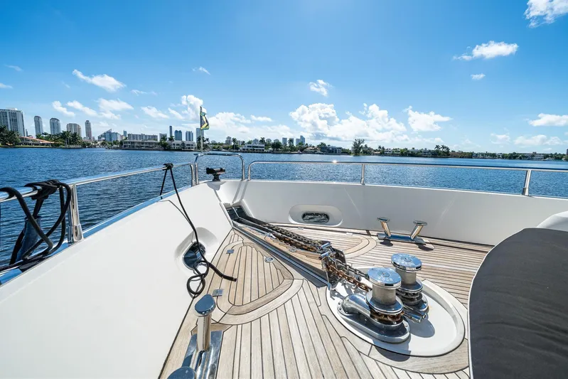 Sukha Yacht Photos Pics Sunseeker 90 Yacht 2008 deck view with city skyline and blue sky.