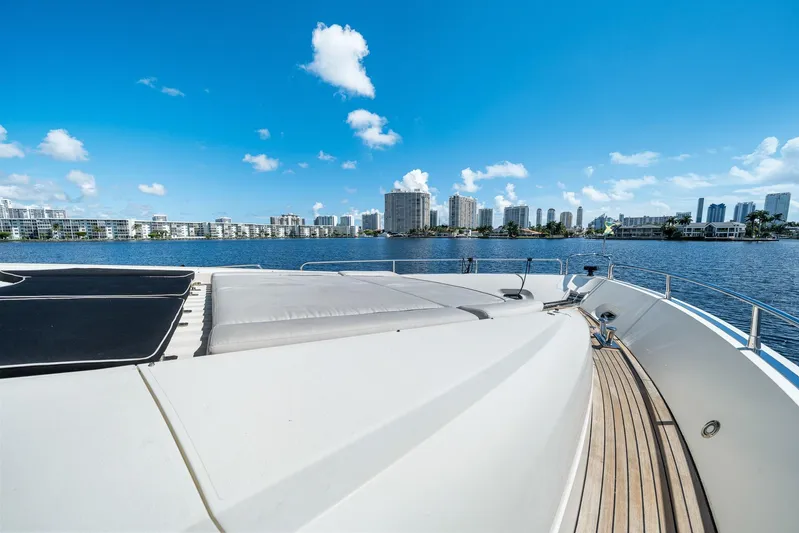Sukha Yacht Photos Pics 2008 Sunseeker 90 Yacht deck with city skyline and blue sky background.