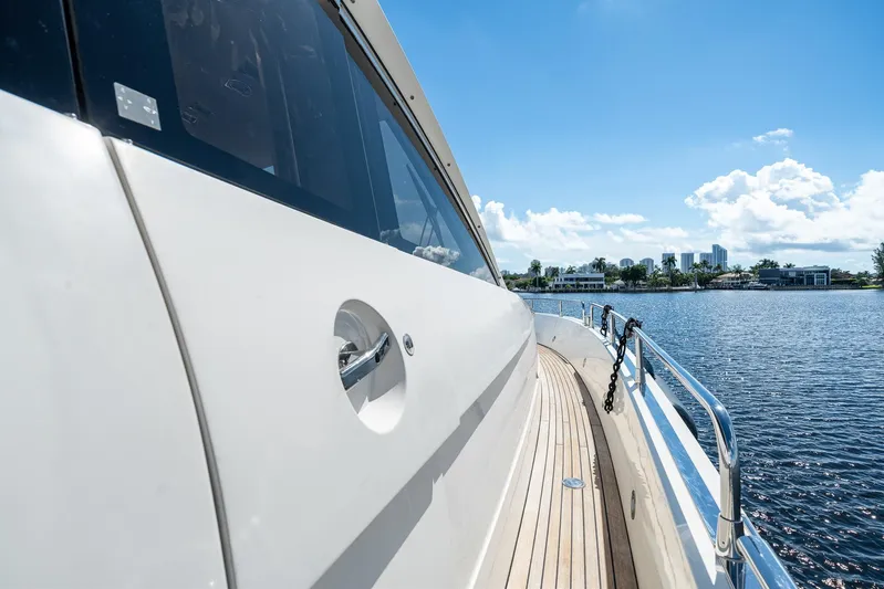 Sukha Yacht Photos Pics 2008 Sunseeker 90 Yacht cruising on a sunny day, showcasing sleek design and waterfront view.