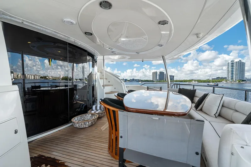 Sukha Yacht Photos Pics Luxurious 2008 Sunseeker 90 Yacht deck with elegant seating and scenic waterfront views.