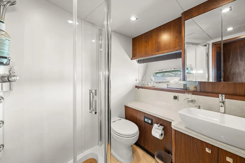 Sukha Yacht Photos Pics Luxurious bathroom in 2008 Sunseeker 90 Yacht with modern fixtures and elegant wood accents.