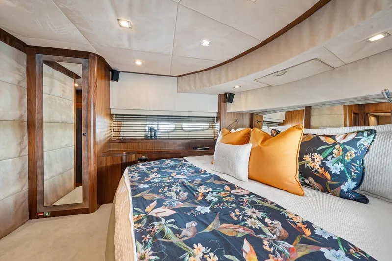 Sukha Yacht Photos Pics Luxurious bedroom interior of 2008 Sunseeker 90 Yacht with floral bedding and elegant wood finishes.
