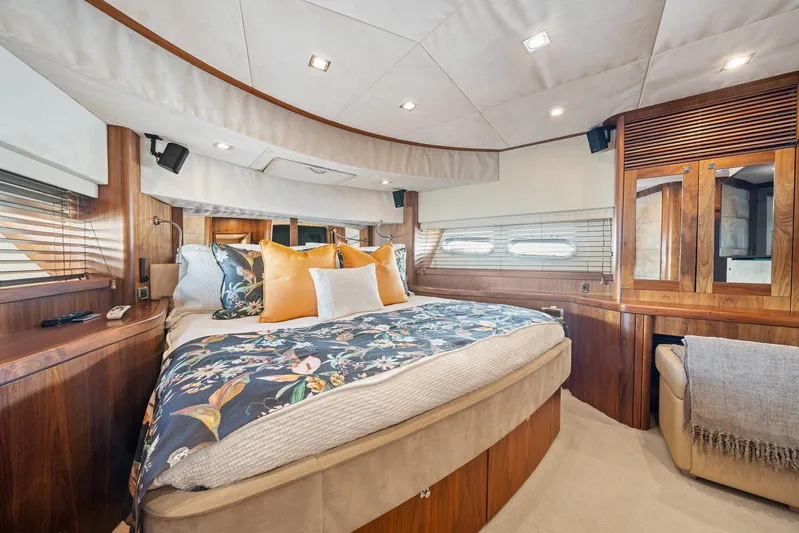 Sukha Yacht Photos Pics Luxurious bedroom interior of 2008 Sunseeker 90 Yacht with elegant wood finishes and plush bedding.