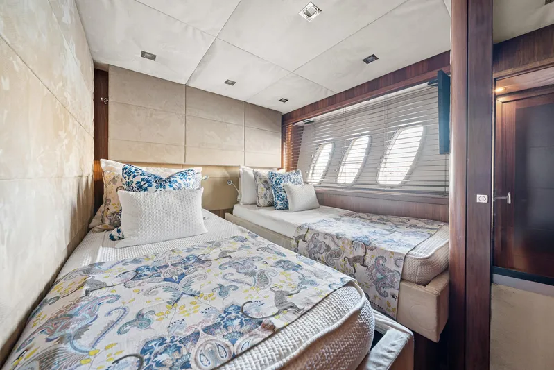Sukha Yacht Photos Pics Luxurious twin bedroom in 2008 Sunseeker 90 Yacht with elegant decor and natural light.