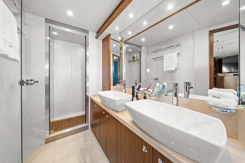Sukha Yacht Photos Pics Luxurious bathroom on a 2008 Sunseeker 90 Yacht with dual sinks and modern shower.