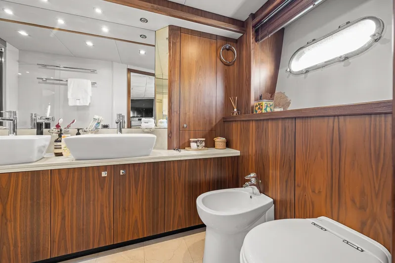 Sukha Yacht Photos Pics Luxurious bathroom on 2008 Sunseeker 90 Yacht with wood paneling and modern fixtures.