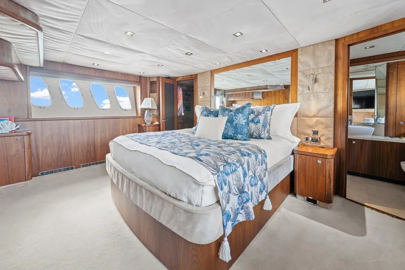 Sukha Yacht Photos Pics Luxurious bedroom interior of 2008 Sunseeker 90 Yacht with elegant wood paneling.