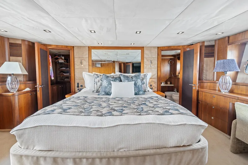 Sukha Yacht Photos Pics Luxurious bedroom interior of 2008 Sunseeker 90 Yacht with elegant wood finishes.