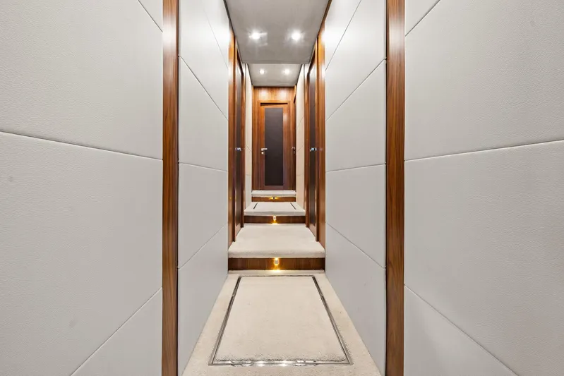 Sukha Yacht Photos Pics Luxurious hallway interior of 2008 Sunseeker 90 Yacht with elegant wood paneling.