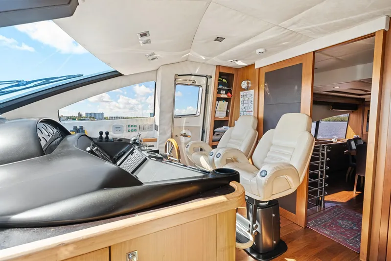 Sukha Yacht Photos Pics Luxurious interior of 2008 Sunseeker 90 Yacht with modern helm and plush seating.