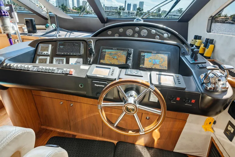 Sukha Yacht Photos Pics Cockpit of 2008 Sunseeker 90 Yacht with navigation controls and steering wheel.