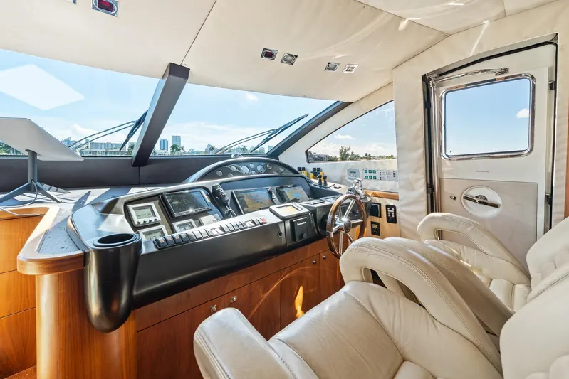 Sukha Yacht Photos Pics Luxurious 2008 Sunseeker 90 Yacht helm with modern controls and plush seating.