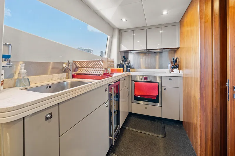 Sukha Yacht Photos Pics Modern kitchen interior on 2008 Sunseeker 90 Yacht, featuring sleek cabinetry and stainless steel appliances.