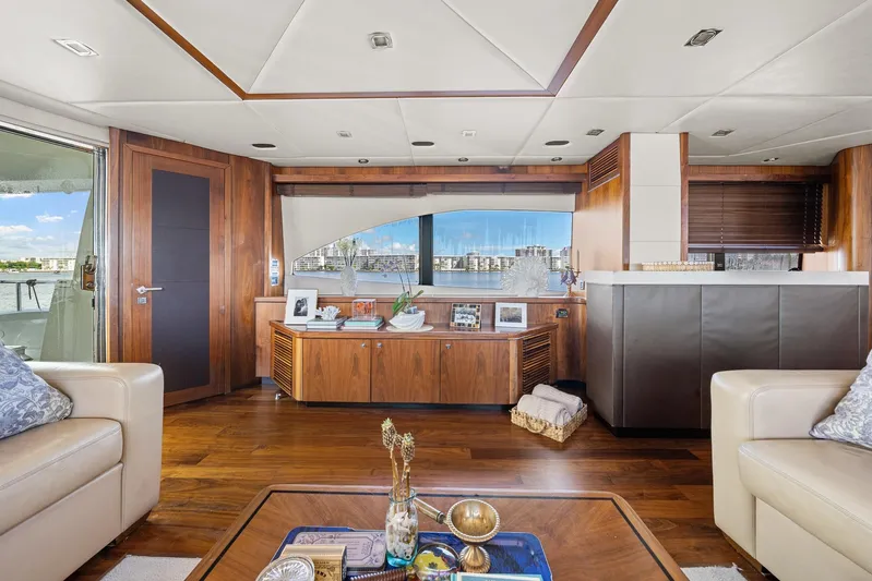 Sukha Yacht Photos Pics Luxurious interior of 2008 Sunseeker 90 Yacht with elegant wood finishes and waterfront view.