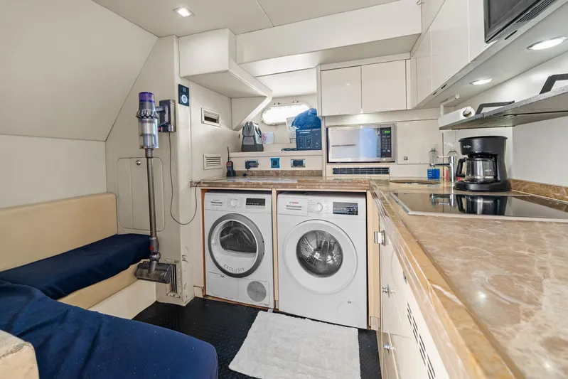 Sukha Yacht Photos Pics Laundry area and kitchenette in 2008 Sunseeker 90 Yacht with modern appliances.