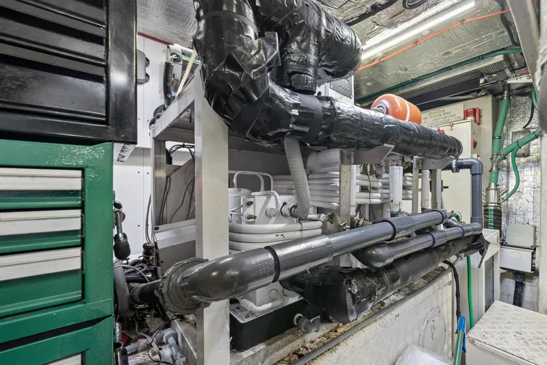 Sukha Yacht Photos Pics Engine room of a 2008 Sunseeker 90 Yacht, showcasing complex piping and machinery.