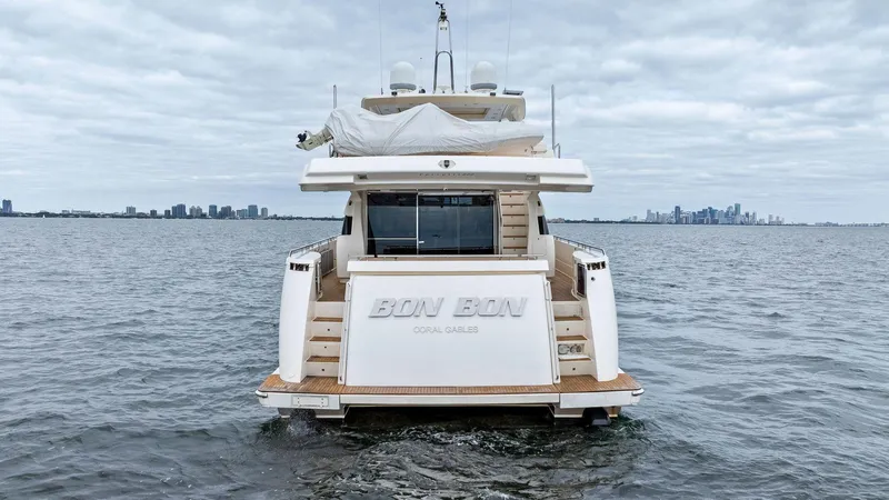 Bon Bon Yacht Photos Pics Rear view of 2012 Ferretti Yachts 800 on open water, city skyline in background.
