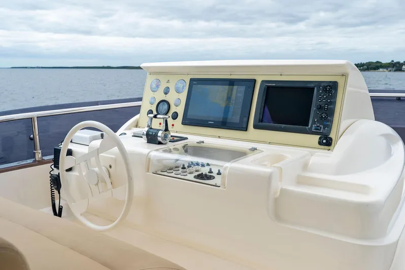 Bon Bon Yacht Photos Pics Ferretti Yachts 800 helm with navigation screens, 2012 model, overlooking calm waters.