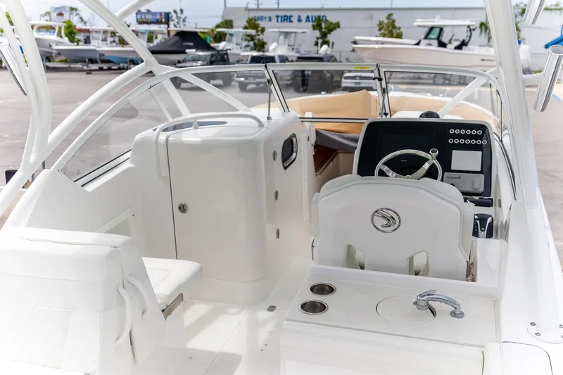  Yacht Photos Pics 2023 Edgewater 248 CX boat interior with steering wheel and seating.