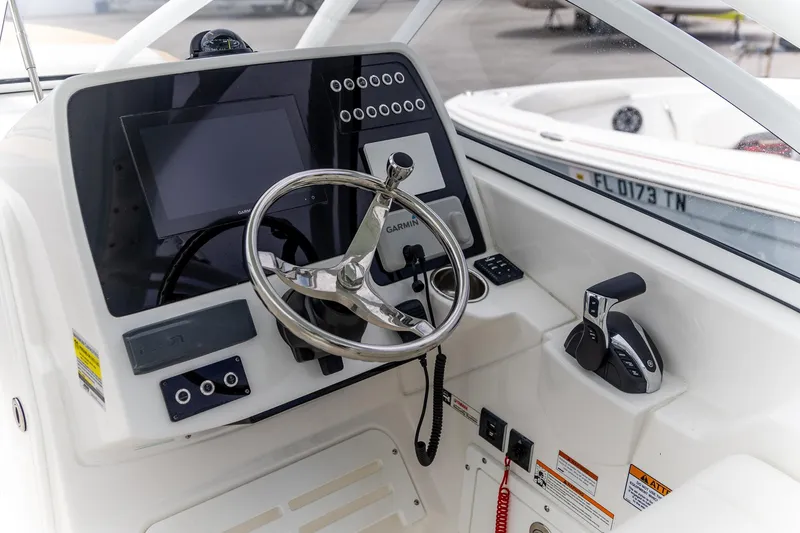 Yacht Photos Pics 2023 Edgewater 248 CX boat dashboard with steering wheel and controls.