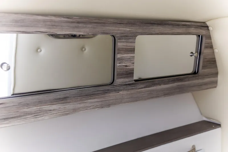  Yacht Photos Pics 2023 Edgewater 248 CX interior with wood finish and mirrored cabinets.