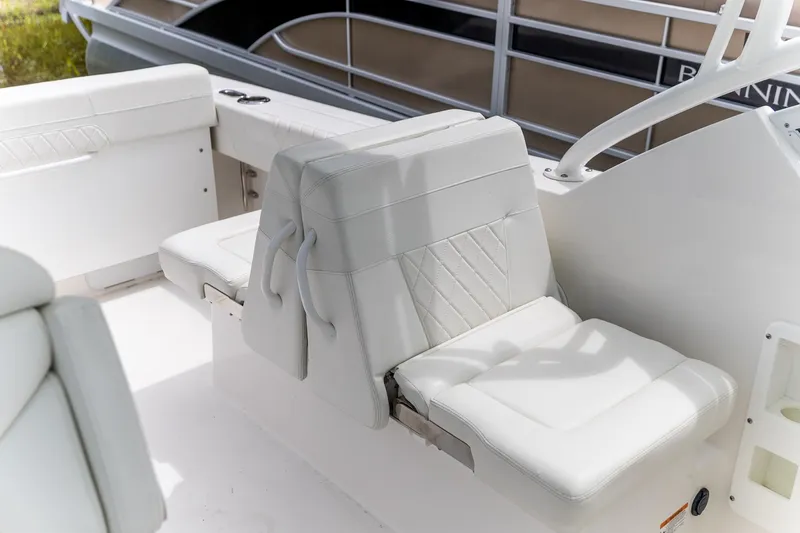  Yacht Photos Pics 2023 Edgewater 248 CX boat interior with white cushioned seating.