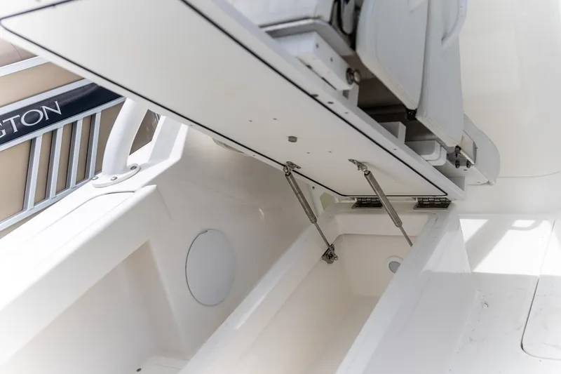  Yacht Photos Pics 2023 Edgewater 248 CX boat storage compartment with open hatch and hydraulic supports.
