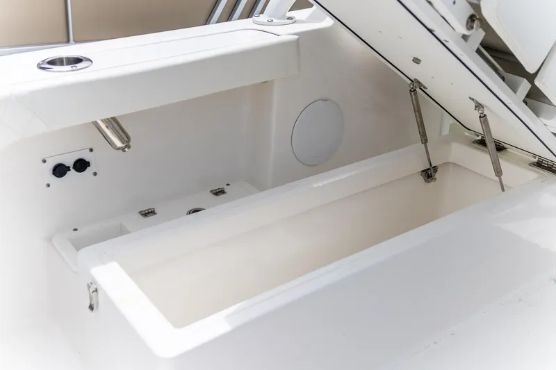  Yacht Photos Pics Open storage compartment on 2023 Edgewater 248 CX boat, showcasing interior features.
