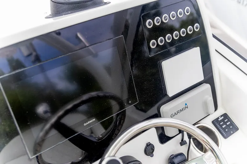  Yacht Photos Pics 2023 Edgewater 248 CX boat dashboard with Garmin navigation system and control panel.