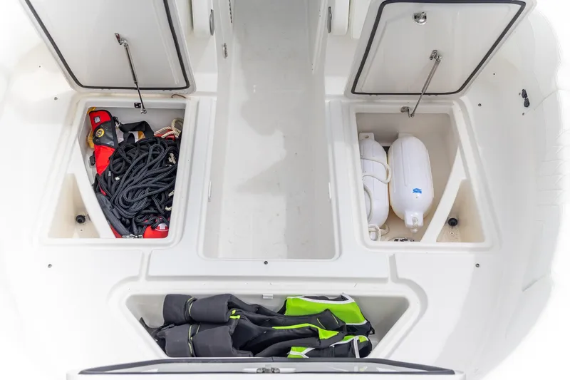  Yacht Photos Pics 2023 Edgewater 248 CX boat storage compartments with ropes, fenders, and gear.