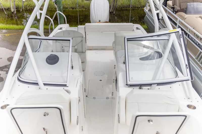  Yacht Photos Pics 2023 Edgewater 248 CX boat interior with seating and open windshield.