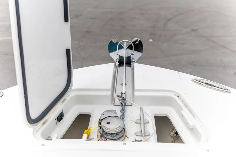  Yacht Photos Pics 2023 Edgewater 248 CX boat anchor compartment with open hatch and visible chain.