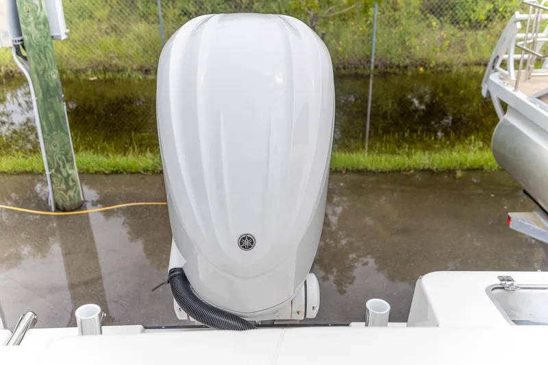  Yacht Photos Pics 2023 Edgewater 248 CX boat with Yamaha outboard motor, docked near water.