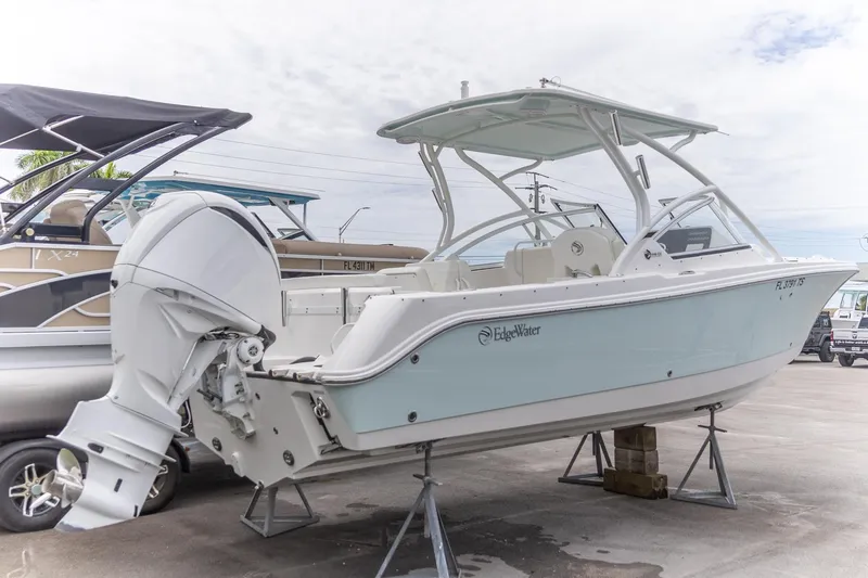  Yacht Photos Pics 2023 Edgewater 248 CX boat on display, featuring sleek design and powerful outboard motor.