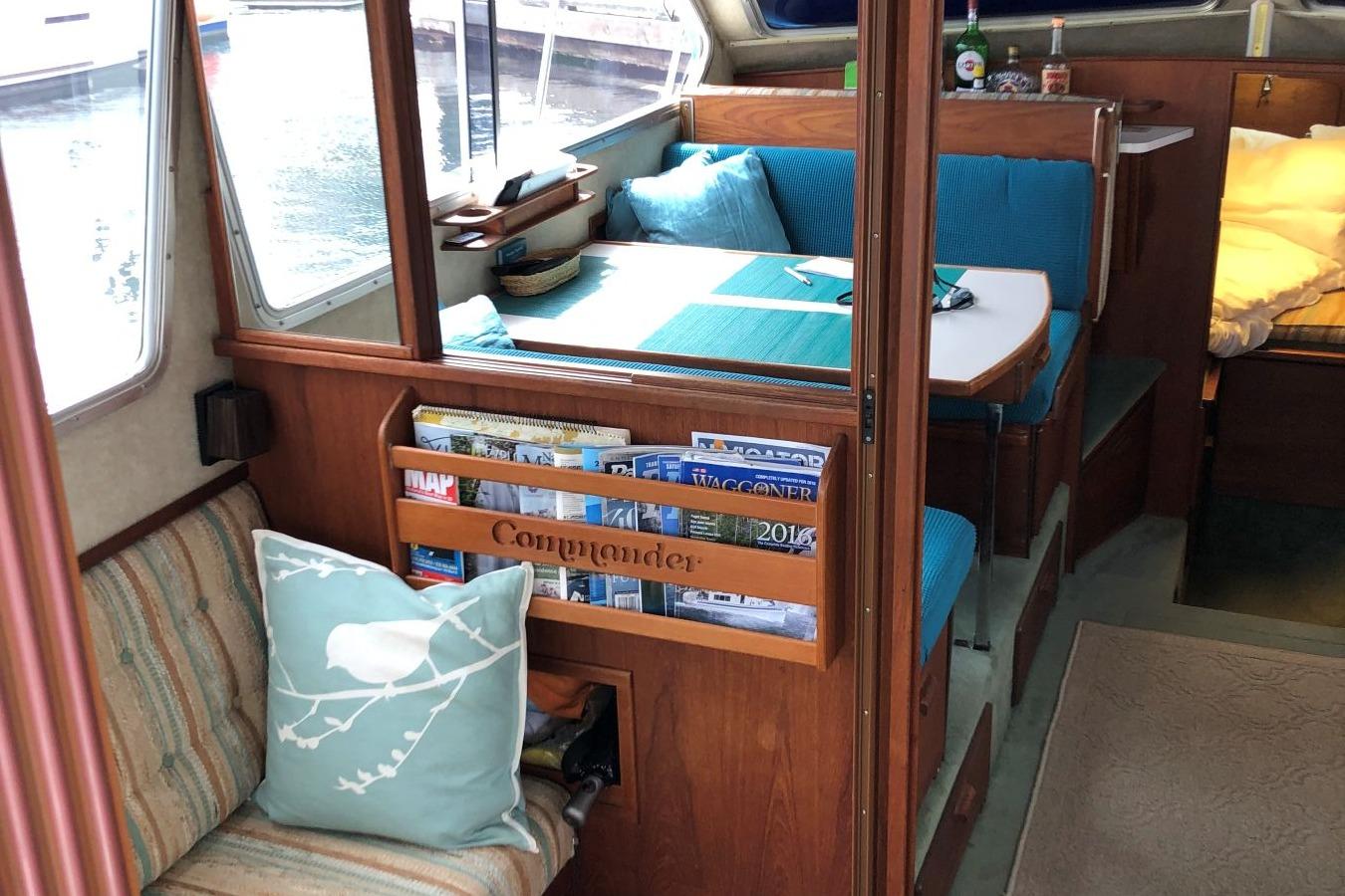 Interior of 1988 Commander 30 Command Bridge with cozy seating and nautical decor.