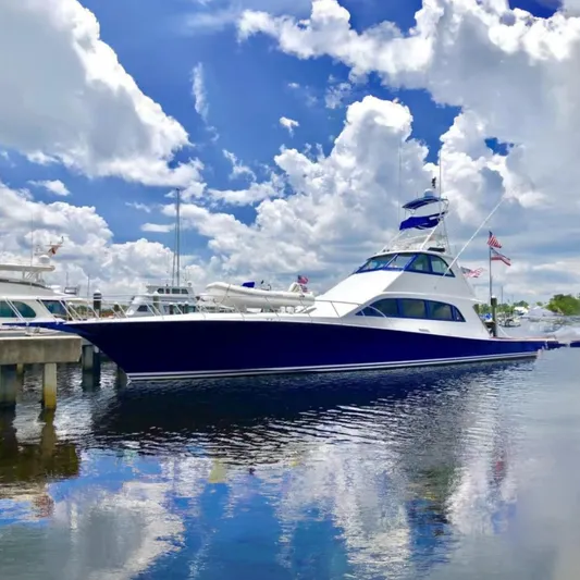 Prime Time Yacht Photos Pics 1993 Palmer Johnson Sportfish yacht docked under a partly cloudy sky.