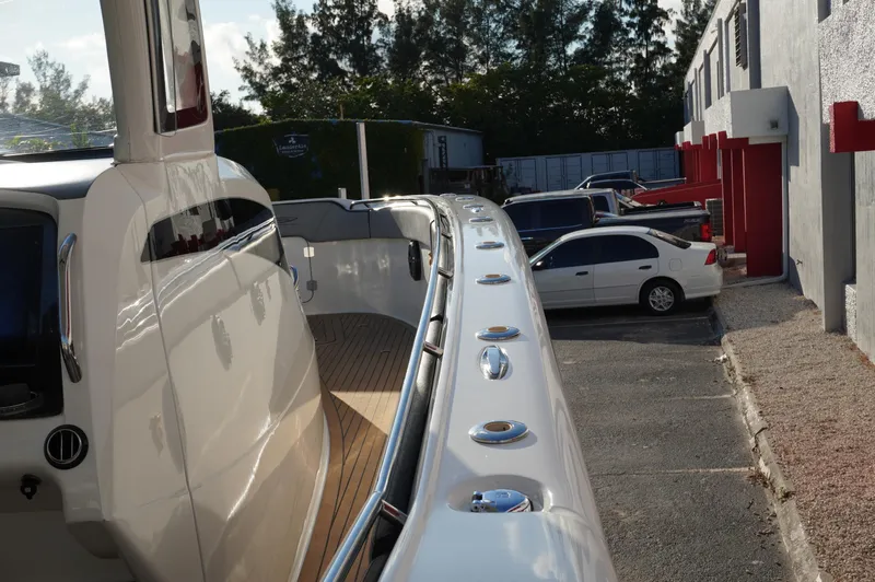  Yacht Photos Pics 2015 MTI 42 XSF boat docked near parked cars in a lot.