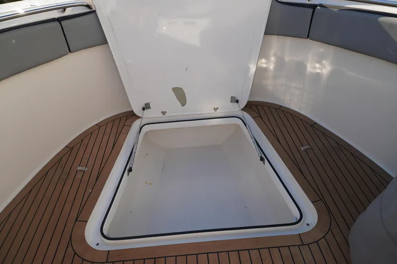  Yacht Photos Pics Open storage compartment on 2015 MTI 42 XSF boat with wooden deck.
