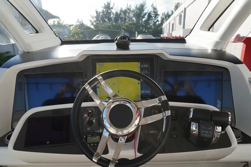  Yacht Photos Pics 2015 MTI 42 XSF boat dashboard with steering wheel and navigation screens.
