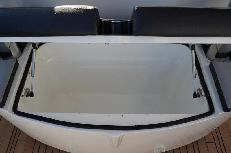  Yacht Photos Pics Open storage compartment on 2015 MTI 42 XSF boat with cushioned seating.