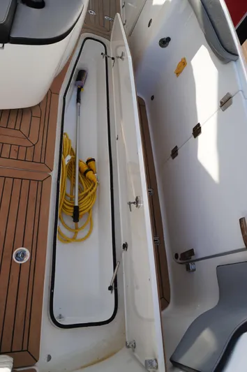  Yacht Photos Pics 2015 MTI 42 xsf boat storage compartment with hose and nozzle.
