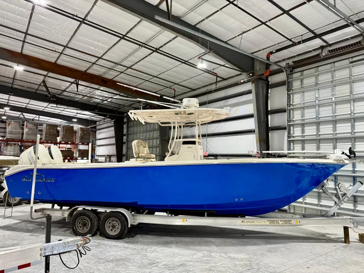  Yacht Photos Pics 2020 Sea Chaser 30 HFC CC boat in warehouse, vibrant blue hull on trailer.